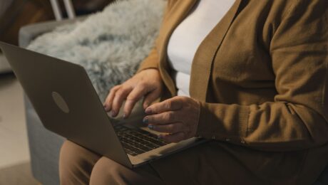 aposentadoria híbrida por idade Mulher madura usando notebook em conteúdo sobre aposentadoria híbrida por idade