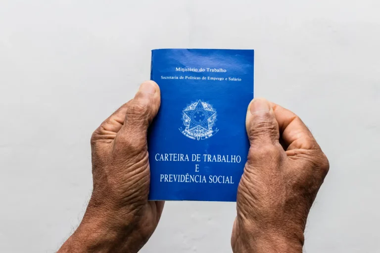 hands-black-senior-man-holding-work-book-brazilian-social-security-document