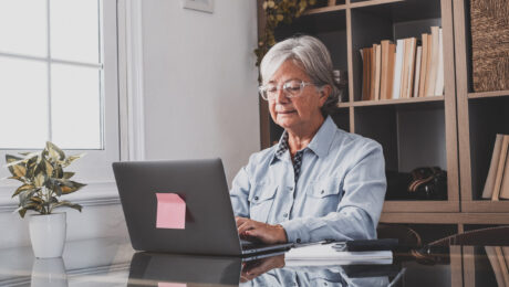 young-man-using-mobile-phone-while-sitting-table