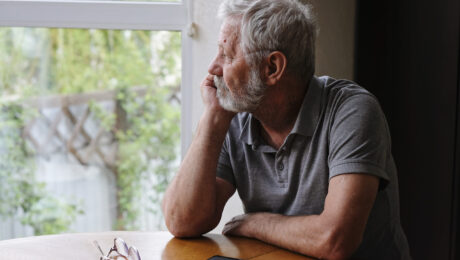 Senior retired man sitting at home alone while quarantine