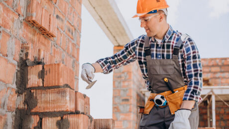 Young craftsman building a house