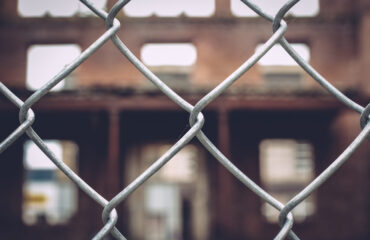 view-building-seen-through-chainlink-fence