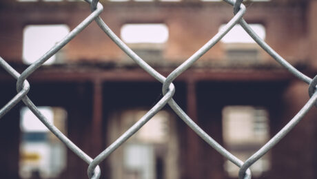view-building-seen-through-chainlink-fence